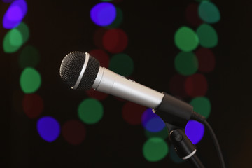 Microphone against dark background with defocused lights