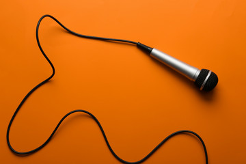 Microphone on color background