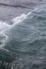 Naklejka na ściany i meble Waves on the seashore as an abstract background