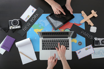 Travel agents choosing tour for client in office, top view
