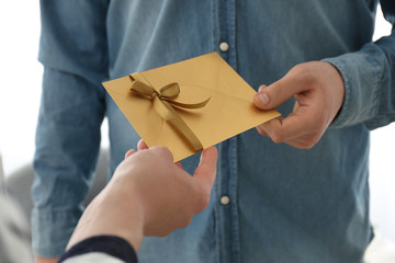 Man receiving wedding invitation, closeup