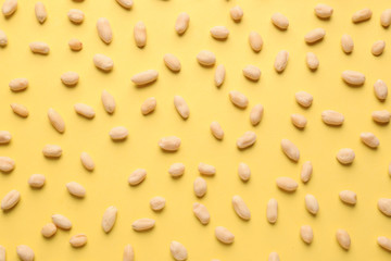 Tasty peanuts on color background