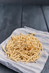 Dark photo of homemade pasta Trofie from Liguria . Italian healthy food concept with copy space. Soup with homemade pasta and meat