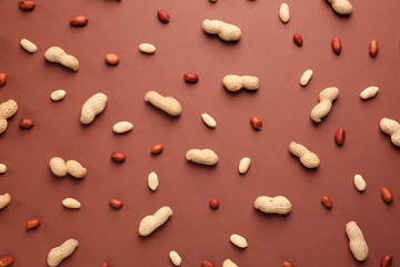 Tasty peanuts on color background