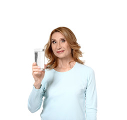 Mature woman with glass of water on white background