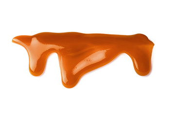Stains of liquid caramel on white background