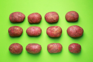 Raw potato on color background