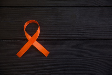 Orange ribbon symbol of leukemia, cancer awareness month.