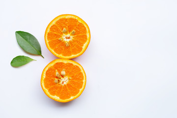 Orange fruit with green leaves on white