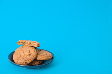 cookies on blue background. oatmeal cookie with pieces of chocolate