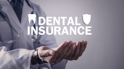 Doctor holding Dental Insurance text.