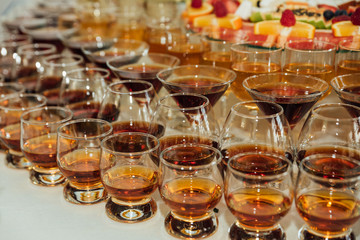 a lot of alcohol drinks on buffet table, catering
