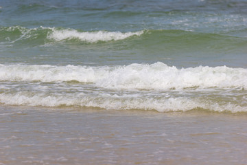 Fototapeta na wymiar Close up detail of the sea waves washing ashore at the beach Asia Thailand