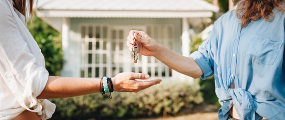 Real-estate agent giving keys to new property owners