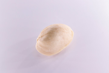 Peeled and unpeeled pistachio nuts isolated on white background