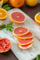 Naklejka na ściany i meble Grapefruit and oranges are on the wooden table.