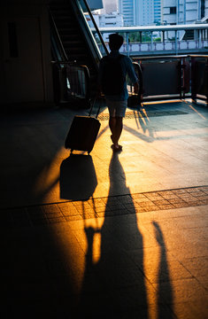 commuter silhouettes in a station in early morning