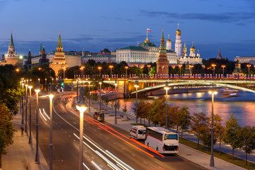 Evening view of Moscow street. Embankment of Moscow river. Traces of car headlights moving cars.	