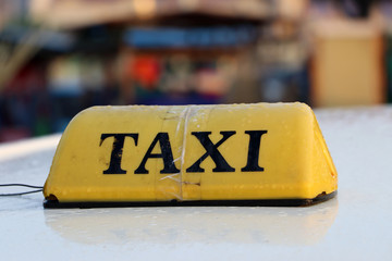 Taxi light sign or cab sign in yellow color with black text and tied with transparent tape on the...