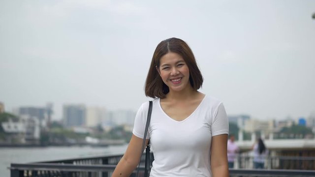 Portrait young asian woman attractive smile look at camera. Feel happy girl summer beautiful slow motion.