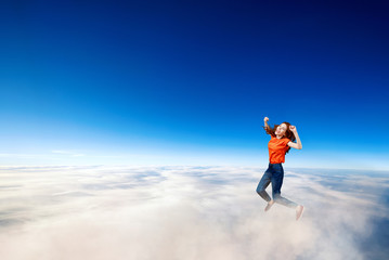 Fototapeta na wymiar Young woman failed and falling down in clouds sea.