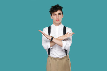 Serious man showing X sign and looking at camera.