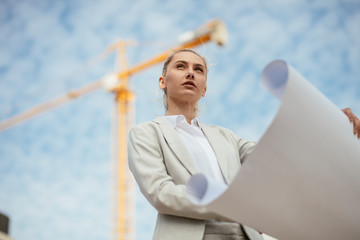 Architect presenting a new plan. Businesswoman with blueprints.