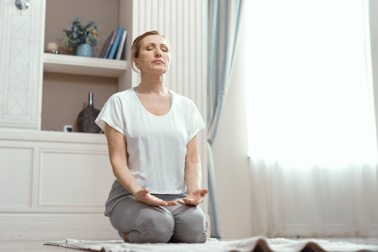 Attractive Mature Woman Is Practicing Yoga In Peace