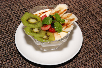 milky desert with kiwi, cherry, banana, mint and chocolate toping