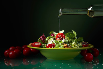 Green salad with cherry tomatoes, sesame and walnuts.