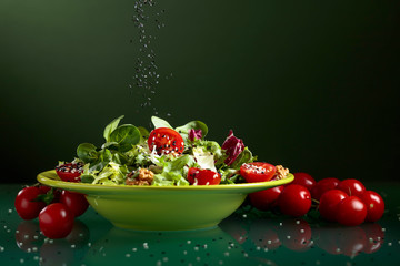 Green salad with cherry tomatoes, walnuts and sesame.