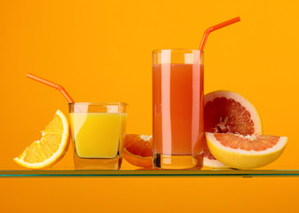 Glasses of fresh grapefruit and orange juice.