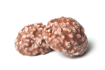 closeup of milk chocolate in shaped rock on white background