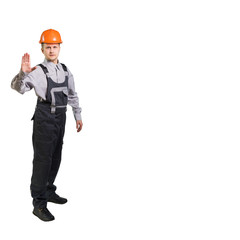 Engineer builder in a helmet, shows a prohibitive sign of the palm. isolated