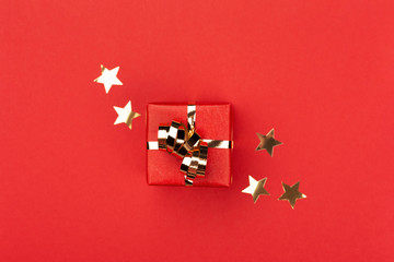 Red gift box on red background.