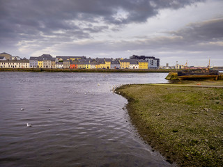Galway city, River Corrib. Cloudy sky, Colorful houses.