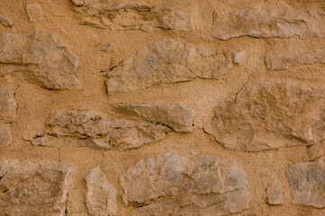 A background with a stone wall with brown tone
