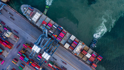 Aerial top view container cargo ship unloading in import export business logistic and...
