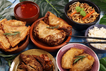 Assorted Chinese food set. Chinese noodles, fried rice, peking duck, dim sum, spring rolls. Famous Chinese cuisine dishes on table. Chinese restaurant