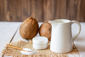Coconuts and coconut milk. Wooden background.