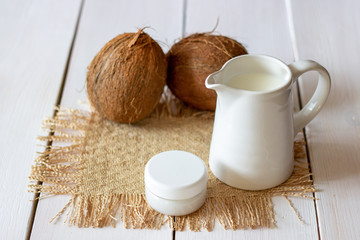 Coconuts and coconut milk. Wooden background.