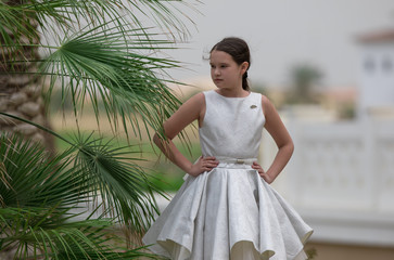 little girl in a white dress on the tropics