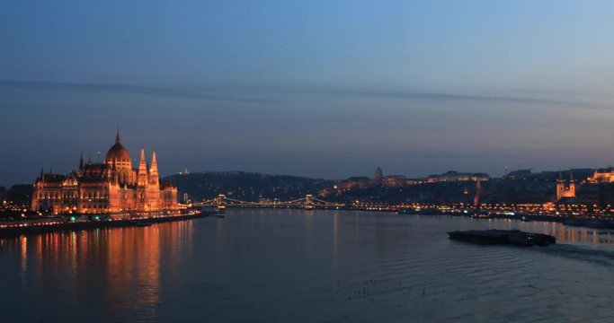 A view of Hungarian Parliament building and Danube river at night. Time lapse