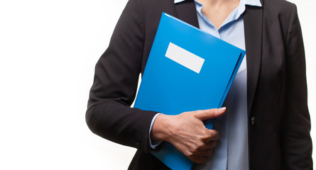 Close up of young woman in a business suit holding a file or a binder. Copy space