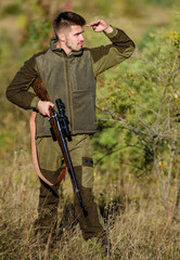 Man brutal unshaved gamekeeper nature background. Hunting permit. Bearded serious hunter spend...