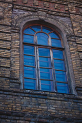 The window of the old building in the branches