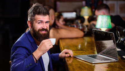 Freelance benefit. Manager work online while enjoy coffee. Hipster freelancer work online blog notebook. Surfing internet. Online job. Man bearded businessman sit pub with laptop and cup of coffee