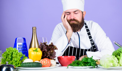 Bored chef lean on table at kitchen. Culinary inspiration. Hard day at restaurant. Tired and exhausted chef. Man bearded chef cooking food. Chef fed up of boring meals. Looking for inspiration