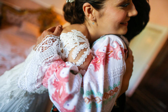 Happy bride embrance her mother in hotel room