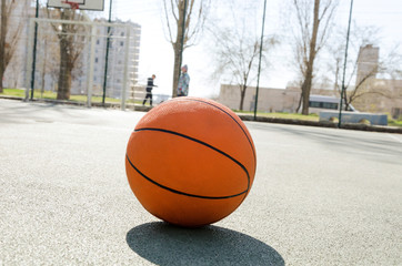 Closeup of orange ball for basketball on the rubber sport court.Sport ground outdoor in the yard 